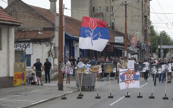Right-wing extremists gather on a street in central Belgrade, Serbia, Thursday, June 27, 2024. Serbian police on Thursday banned a festival that promotes cultural exchange with Kosovo, in a sign of growing nationalism and government pressure on liberal voices in the Balkan country. The police ban came after several dozen right-wing extremists gathered outside the festival venue, seeking to prevent its holding while waving Serbian flags. 