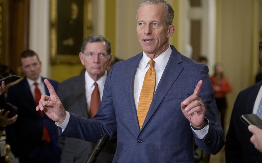 The Senate majority leader speaks with both hands raised, index fingers pointing out.