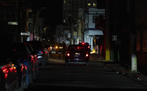 A street is dark during a blackout in San Juan, Puerto Rico, after sunset on Tuesday, Dec. 31, 2024. (AP Photo/Alejandro Granadillo)