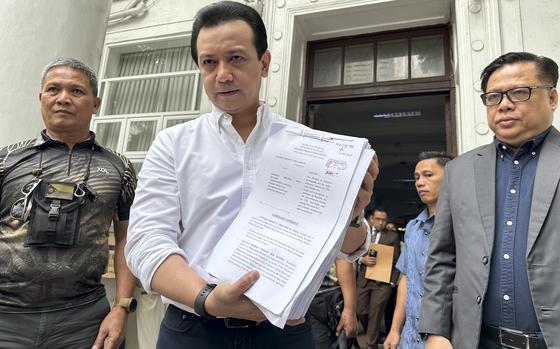 Former Sen. Antonio Trillanes shows documents to reporters after filing at the Department of Justice in Manila, Philippines on Friday July 5, 2024. Trillanes filed criminal complaints of economic plunder against ex-President Rodrigo Duterte Friday over alleged anomalies in the awarding of large numbers of government infrastructure projects worth millions of dollars to two companies when he was a southern city mayor and later as president.
