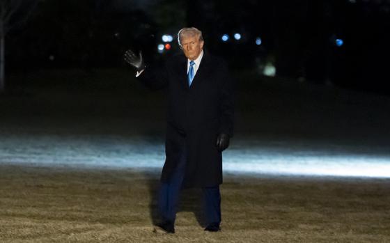 President Donald Trump waves as he walks from Marine One after arriving on the South Lawn of the White House.