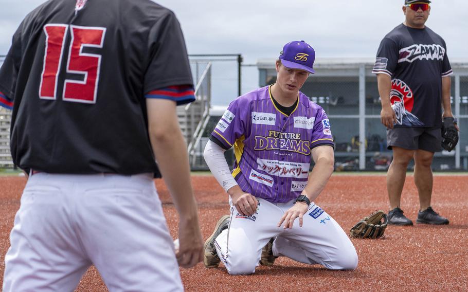 Milan Prokop, a former World Baseball Classic player for the Czech Republic who's now signed to the Kanagawa Future Dreams, gives tips to high school players during a clinic at Yokosuka Naval Base, Japan, May 12, 2024.