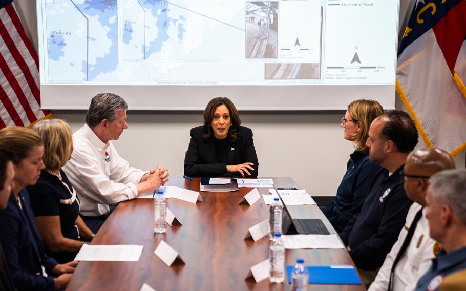 Vice President Kamala Harris joins North Carolina Gov. Roy Cooper (left), FEMA Administrator Deanne Criswell (right) and other officials at a briefing in Charlotte.