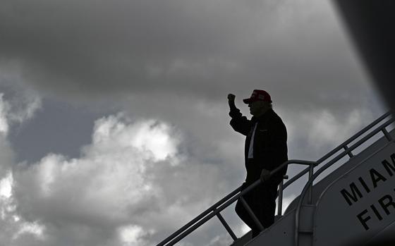 President Donald Trump steps off Air Force One upon arrival at Miami International Airport.