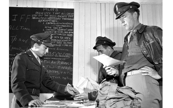 Frankfurt, Germany, July 7, 1948: Berlin Airlift pilots receive their final orders before flying another load of coal out of Rhein-Main Air Base, one of the two hubs (along with Wiesbaden) of the effort to supply the divided city in the face of a Soviet blockade of ground transportation. On the blackboard in the background are strict instructions limiting pilots' radio transmissions, a necessity with planes taking off for Berlin every three minutes.

Looking for Stars and Stripes’ historic coverage? Subscribe to Stars and Stripes’ historic newspaper archive! We have digitized our 1948-1999 European and Pacific editions, as well as several of our WWII editions and made them available online through https://starsandstripes.newspaperarchive.com/

META TAGS: Berlin Airlift; U.S. Air Force; Cold War