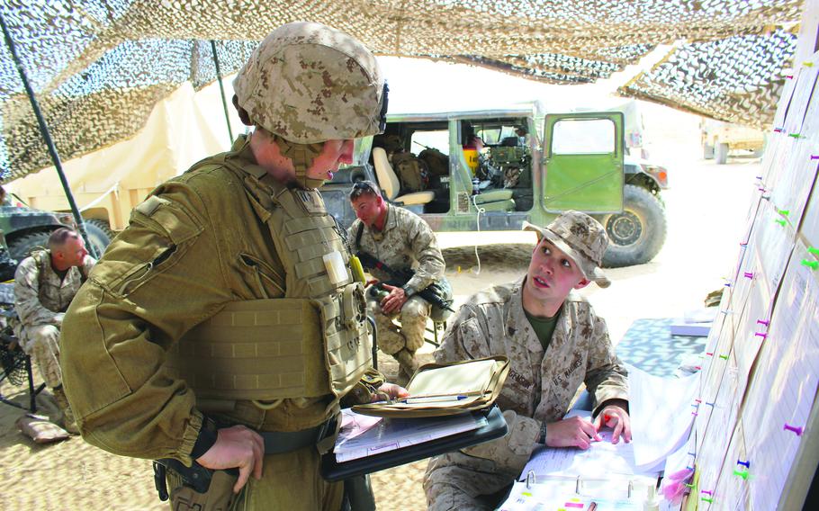 A woman Marine confirming her route with the combat operations center