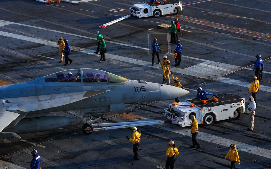 An F/A-18E Super Hornet taxis on the flight deck of the USS George Washington in the Atlantic Ocean, June 23, 2023. 