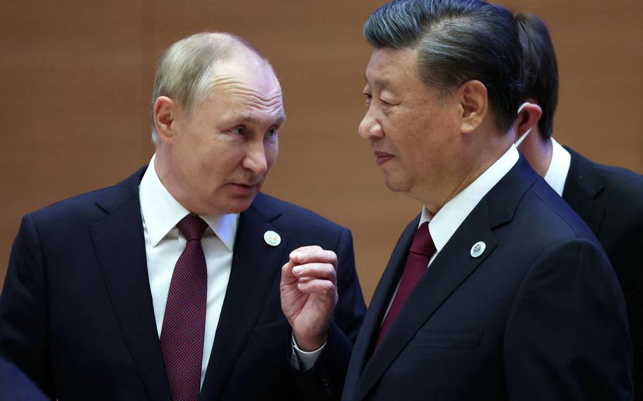 Russia President Vladimir Putin, left, speaks to China President Xi Jinping during the Shanghai Cooperation Organization (SCO) leaders’ summit in Samarkand on Sept. 16, 2022. 