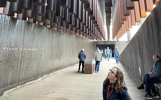 Tobe Rubin of Boca Raton, Fla., examines the names of lynched Americans inscribed at the National Memorial for Peace and Justice in Montgomery, Ala.