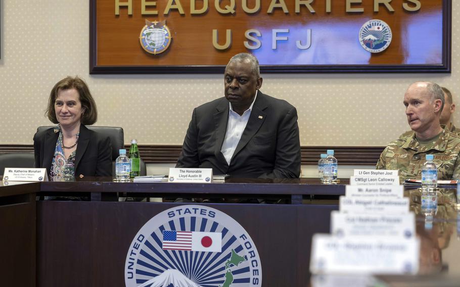 Secretary of Defense Lloyd Austin talks with U.S. Forces Japan officials at Yokota Air Base.