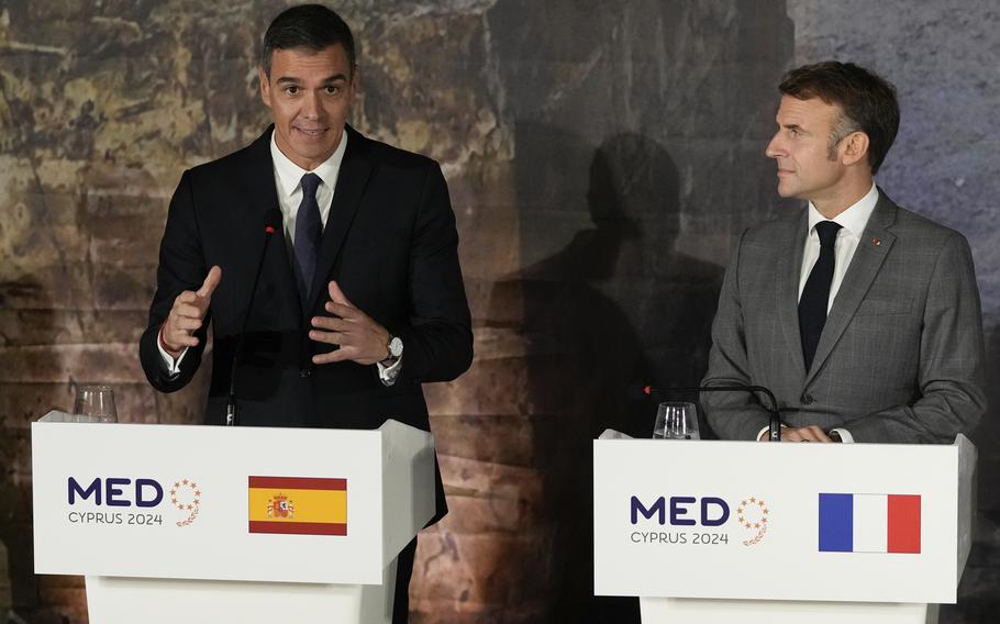 Spain’s Prime minister Pedro Sanchez, left, speaks next to French President Emmanuel Macron during a news conference in Paphos ,Cyprus, on Friday, Oct 11, 2024 as the leaders of nine southern European Union member countries and Jordan are meeting to come up with ways of de-escalating the conflict in the Middle East.