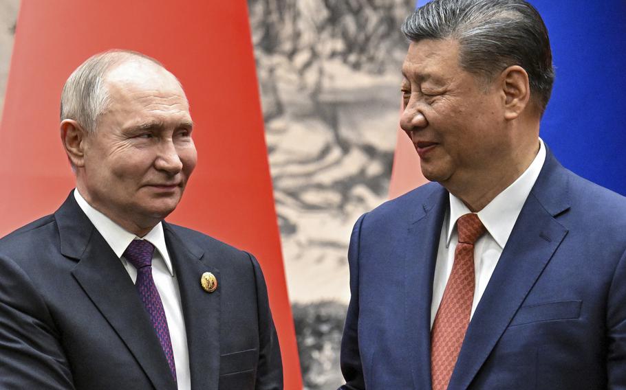 Chinese President Xi Jinping, right, and Russian President Vladimir Putin look toward each other as they shake hands prior to their talks in Beijing, China, Thursday, May 16, 2024. Putin and Xi will meet Thursday for the second time in as many months as they attend the Shanghai Cooperation Organization summit in Astana, Kazakhstan. 