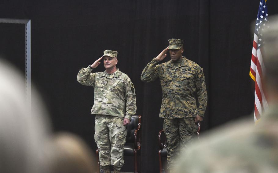 Gen. Christopher Cavoli, leader of U.S. European Command, and Gen. Michael Langley, head of U.S. Africa Command, salute during the national anthem 