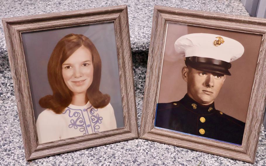 Separate framed photos of Joan and John Reichart from the 1970s. John is wearing his Marine uniform in his photo.