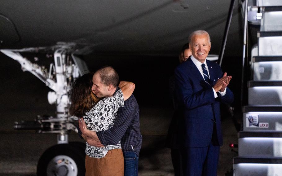 Evan Gershkovich hugs his mother, Ella Milman, after greeting President Biden and Vice President Harris at Joint Base Andrews, Md., on Thursday. 