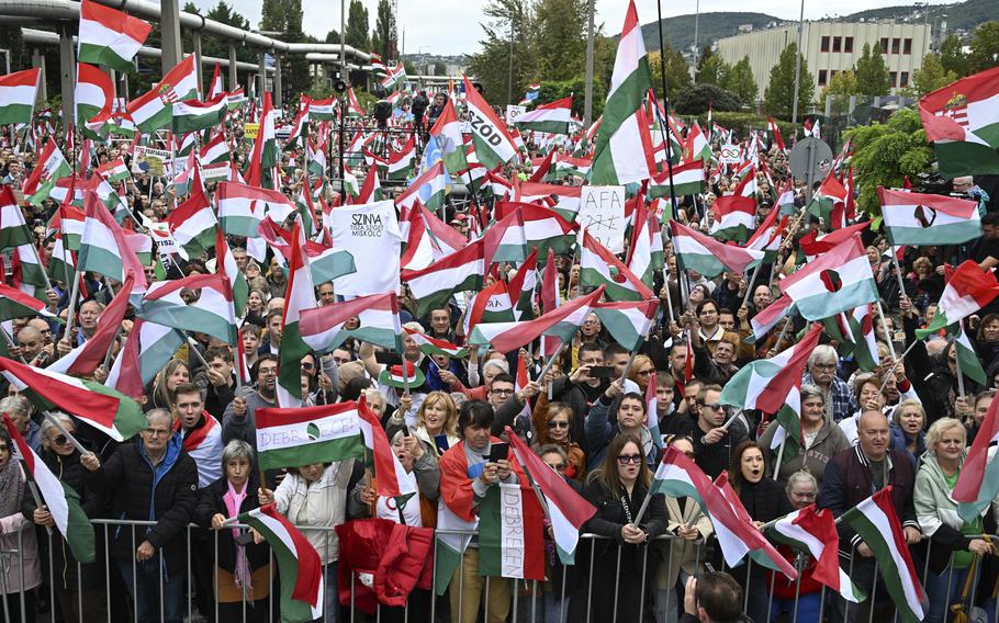 Participants wave national flags during a demonstration organised by the Hungarian opposition Tisza Party against public media at the MTVA headquarters in Budapest, Hungary, Saturday, Oct. 5, 2024.