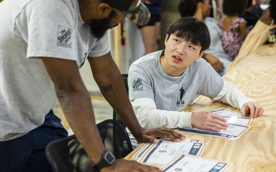 Graduates Chengxian Li, Marine Corps, and Donnel Holmes, Navy, talk about their career aspirations following their graduation ceremony from the Home Builders Institute’s tuition-free skilled trades training program in Norfolk, Va., on Friday, Aug. 4, 2023.