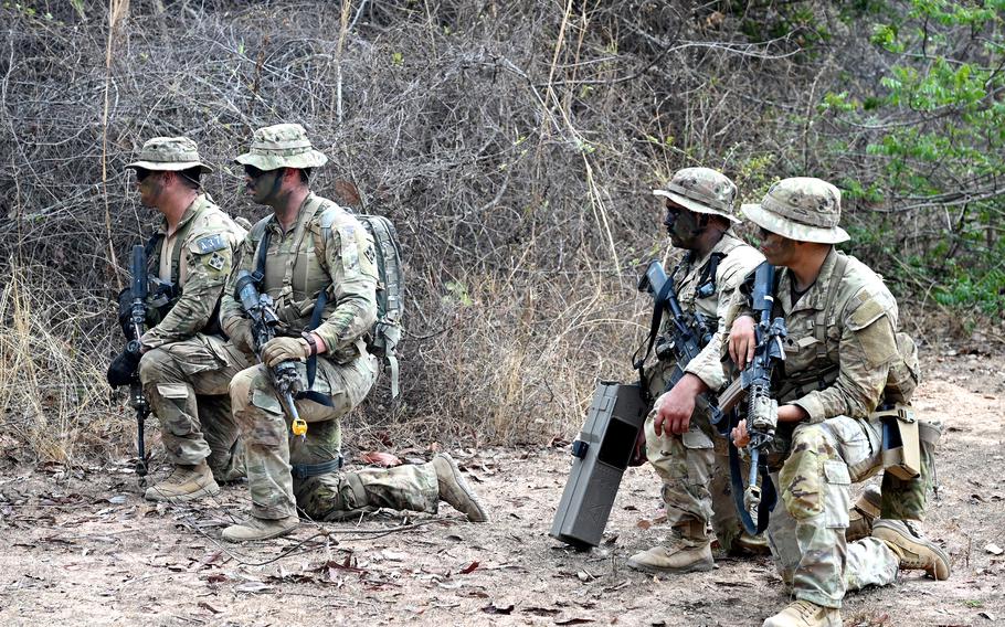 A fireteam from the U.S. Army’s 4th Infantry Division carrying a Dronebuster, center right, holds its position.