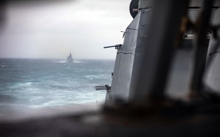 A frigate sails on the ocean.