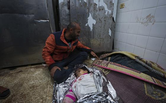 Adly Eid mourns over the body of his daughter, Dima, 5, who was killed in an Israeli airstrike, at the Al-Aqsa Hospital morgue in Deir Al-Balah, Gaza, Saturday, Jan. 11, 2025. (AP Photo/Abdel Kareem Hana)