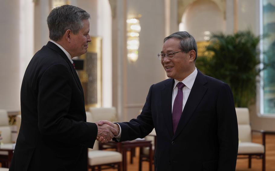 Sen. Steve Daines shakes hands with Li Qiang.