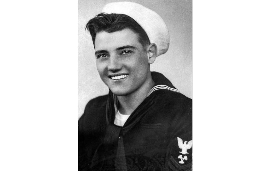 A black-and-white portrait of a World War II-era sailor in uniform.