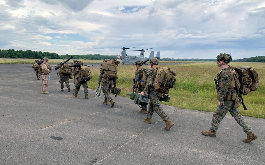 Marines from the 24th Marine Expeditionary Unit walk to a waiting V-22 Osprey as part of a simulated multinational amphibious assault on a Polish air force base at Ustka, Poland, during Baltic Operations 24, June 16, 2024.