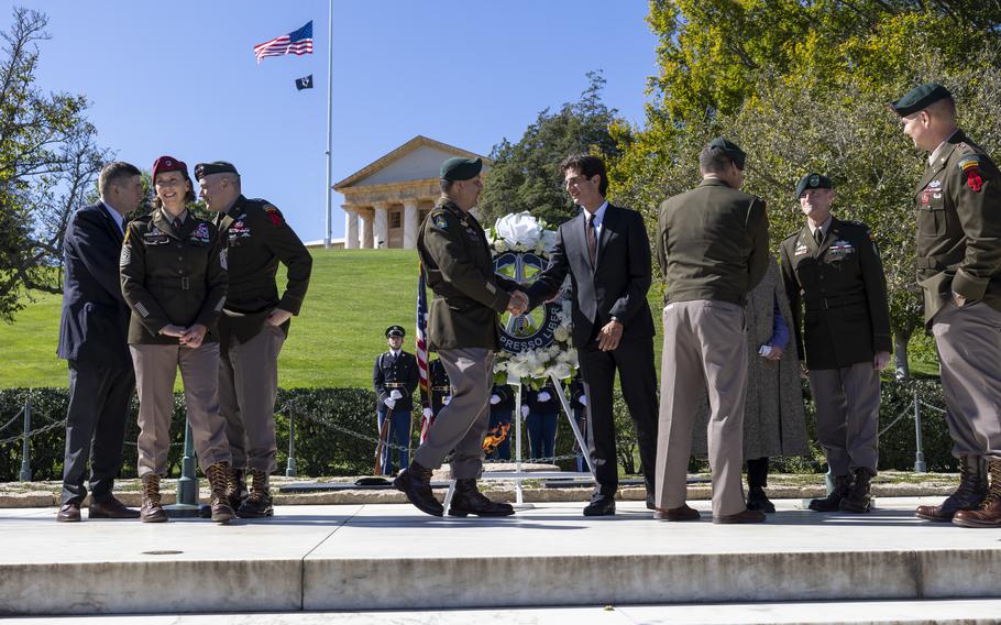 Command chief warrant officer of 1st Special Forces Command (Airborne) shakes hand with the grandson of President John F. Kennedy  at Arlington National Cemetery in Arlington, Va., on Oct. 17, 2024.