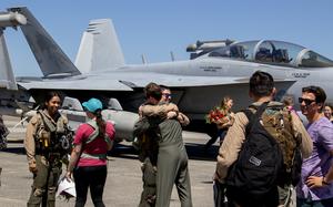 Pilots, assigned to the "Zappers" of Electronic Attack Squadron (VAQ) 130, are greeted by friends,  family and service members upon their return home to Naval Air Station Whidbey Island, Washington, July 13,2024, after a deployment with the Dwight D. Eisenhower Carrier Strike Group. The Dwight D. Eisenhower Carrier Strike Group returned to homeport after a nine-month deployment to the U.S. 5th and 6th Fleet areas of operations to support maritime security, promote regional stability and deter aggressions. (U.S. Navy Photo by Mass Communication Specialist 1st Class William Sykes)