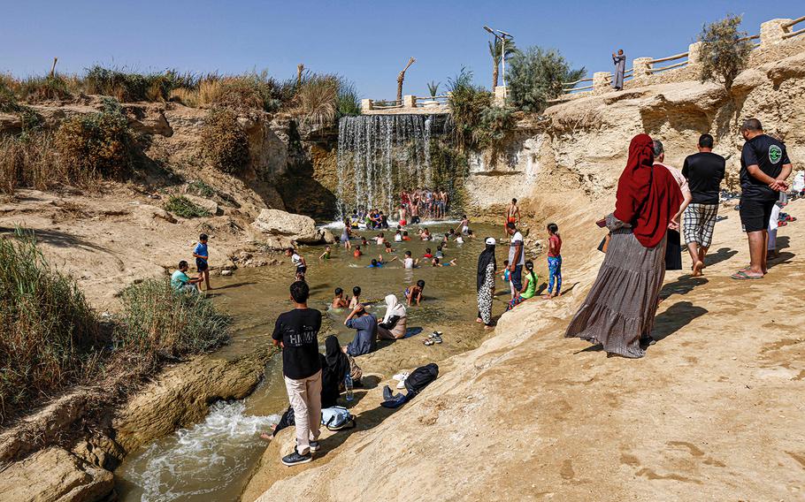 Visitors cool down by Wadi el-Rayan's waterfalls amidst a blistering heatwave, in Fayyum on Aug. 19, 2023.