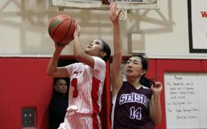 Kinnick's Lindsey Andrade shoots past Seisen's Yuri Yamashita.