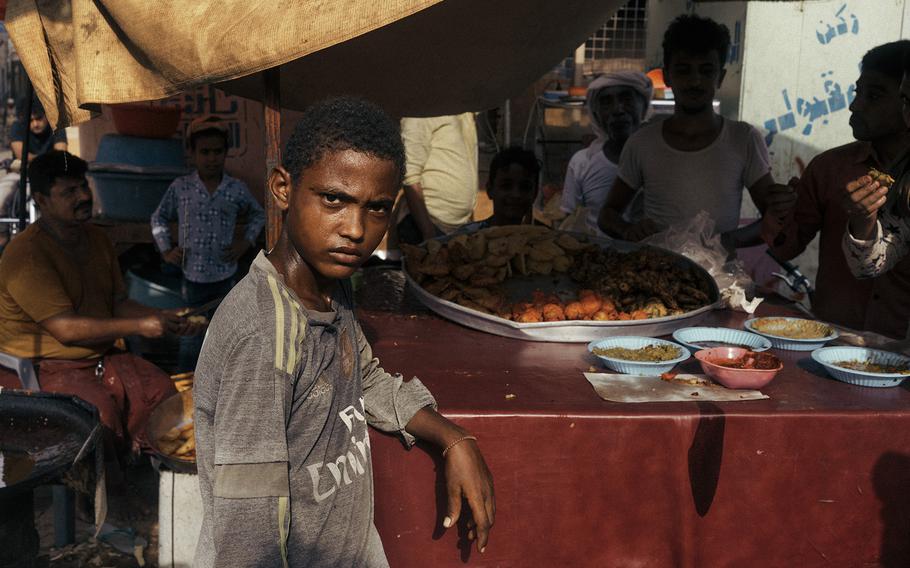 A boy sweats in the heat at a market stall in Hodeida in August 2023.