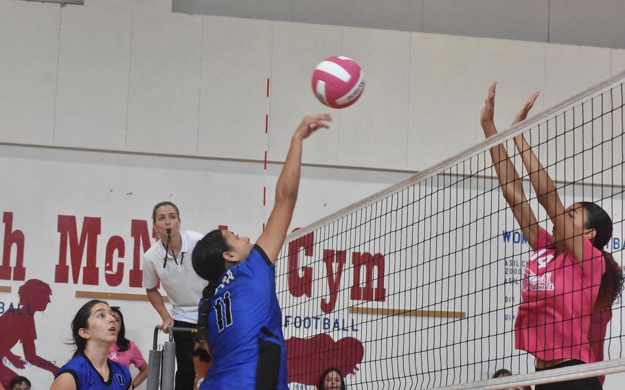 Rota’s Alana Geylani sends the ball over the net while Aviano’s Jazmyn Warren waits for it in the Admirals’ five-set victory on Saturday, Oct. 14, 2023.