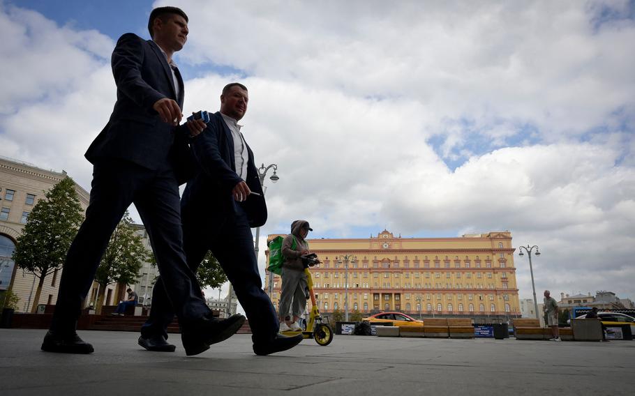 Men walk in front of the headquarters of Russia’s Federal Security Services in central Moscow on Aug. 28, 2023.