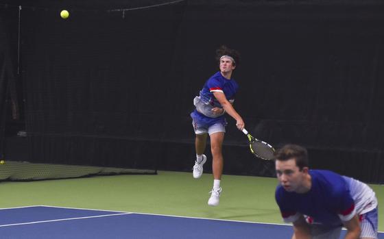 Ramstein's Bernie Novak finishes a strong serve during a semifinals match against Kaiserslautern at the 2024 DODEA European tennis championships in Wiesbaden, Germany.  Novak and his partner Elliot Radosevich upset the No.1 seed Kaiserslautern to advance to the championship finals.