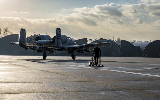 An airman walks toward an A-10C Thunderbolt II at Osan Air Base, South Korea, Dec. 7, 2022.