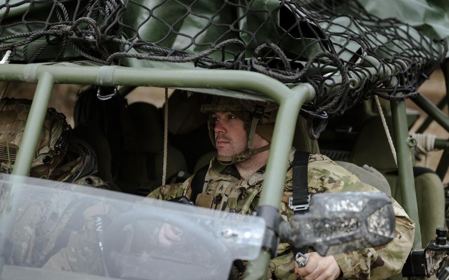 U.S. soldiers drive an infantry squad vehicle.