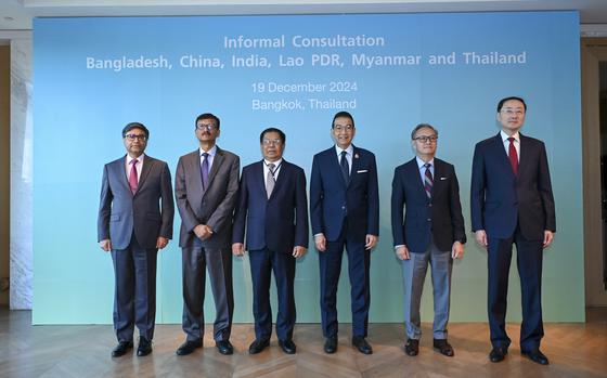 Foreign ministers representing India, Bangladesh, Myanmar, Thailand, Laos and China pose in front of a blue poster.