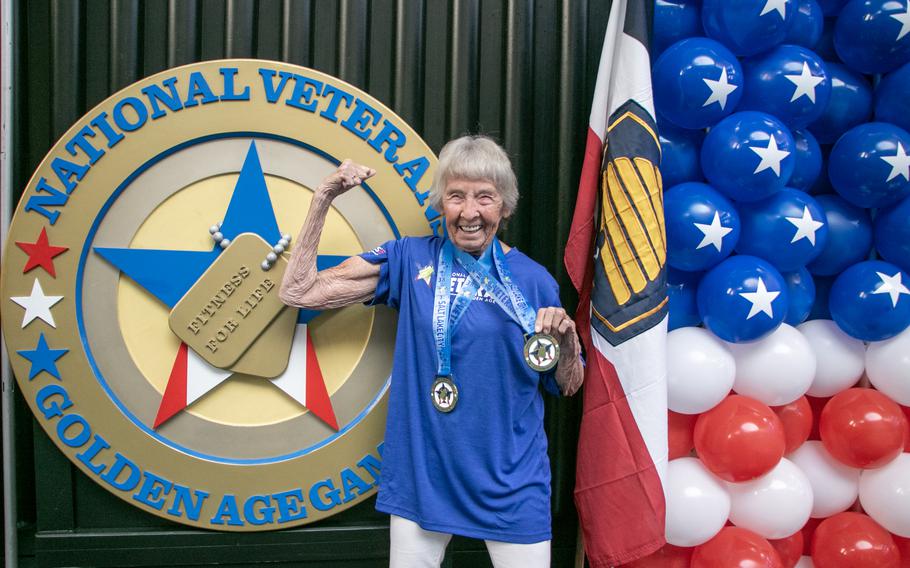 Army veteran Betty St. John flexes her muscles at the 2024 National Veterans Golden Age Games, showing off her “fitness for life” motto.