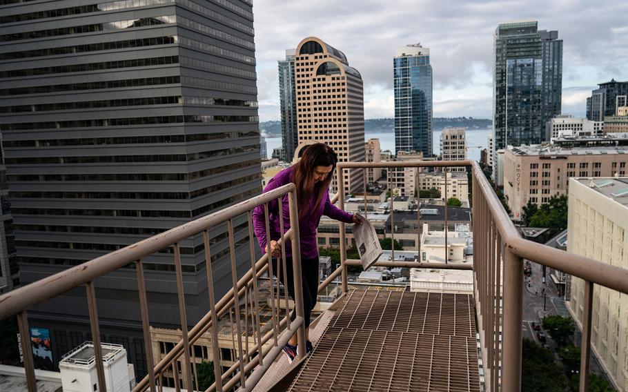 Rachel Twitchell-Justiss visits the roof of the Hotel Theodore, where her relative was photographed 90 years earlier. 