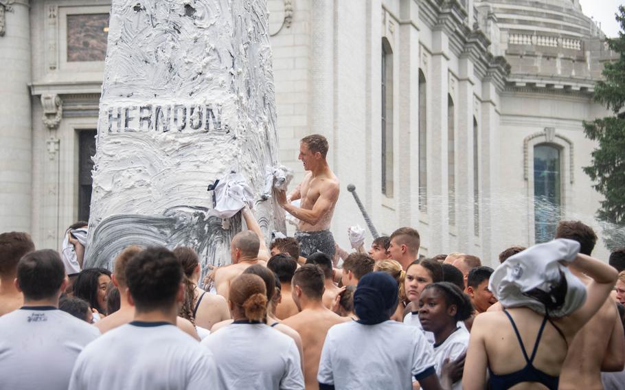 U.S. Naval Academy freshmen, or plebes, climb the Herndon monument, a tradition symbolizing the successful completion of the midshipmen’s freshman year.