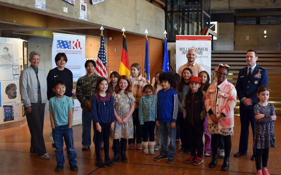 Lord Mayor Beate Kimmel, left,  John Constance from the Atlantische Akademie Rheinland-Pfalz, center, and Major General Paul D. Moga, right, with some of the students who participated in the German-American student art exhibition.