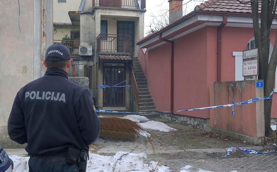 A police officer stands guard at the scene after a shooting incident at a bar, in Cetinje, 36 kilometers (22 miles) west of Podogrica, Montenegro, Thursday, Jan. 2, 2025. (AP Photo/Risto Bozovic)