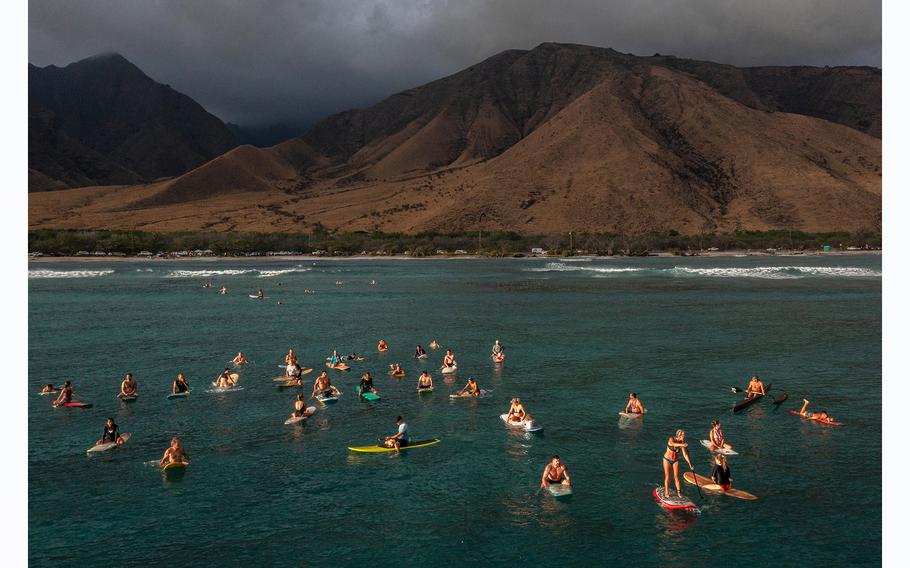 Family and friends of Carole Hartley paddle out from Ukumehame Beach in honor of the 61-year-old canoe club member who is said to have died in the August fires on Maui. 