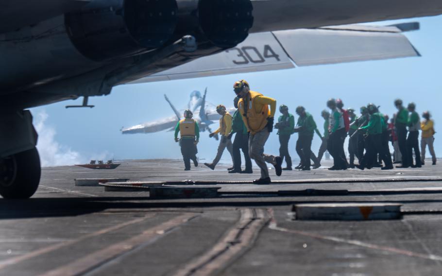 Sailors conduct flight operations on the flight deck of the Nimitz-class aircraft carrier USS Harry S. Truman on April 24, 2024, in the Atlantic Ocean. 