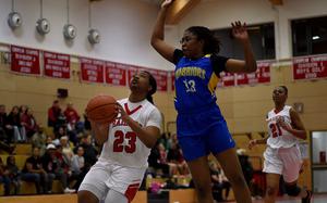 Wiesbaden's Kariyah Housey jumps to swat a layup attempt by Kaiserslautern's Shayla King during a Jan. 14, 2025, game at Kaiserslautern High School in Kaiserslautern, Germany.