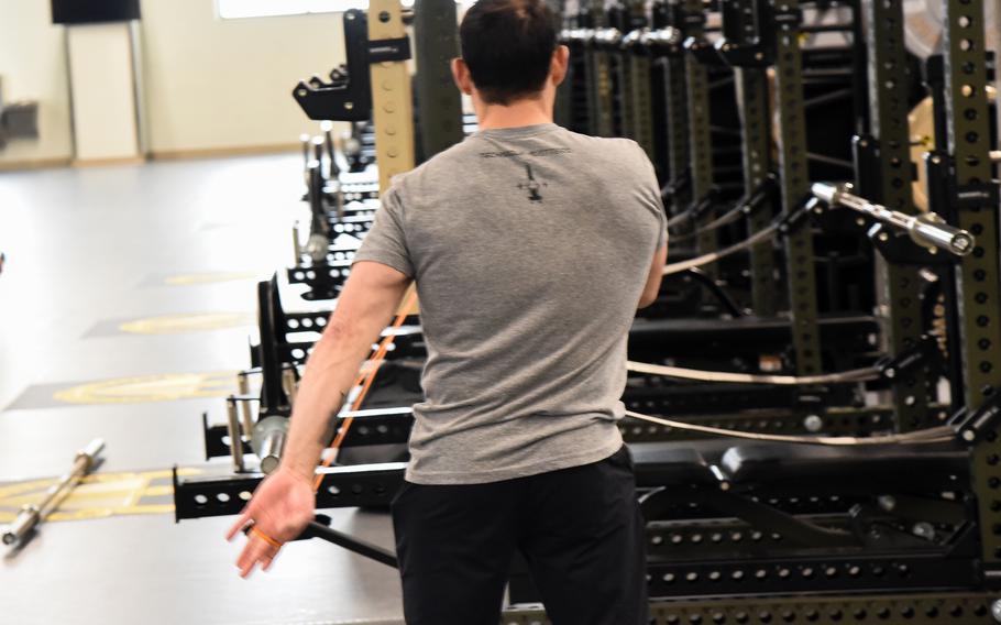 Soldier shown from the back using workout equipment.