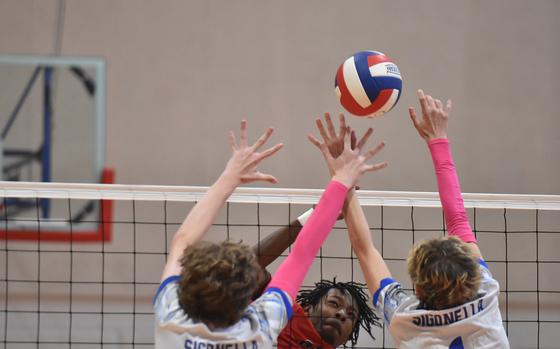 Aviano's Jules Lasalle-Bryant gets the ball past a pair of Sigonella defenders in the Saints' three-set victory over the Jaguars on Saturday, Oct. 5, 2024, at Aviano. Aviano won again later in the day.

Kent Harris/Stars and Stripes