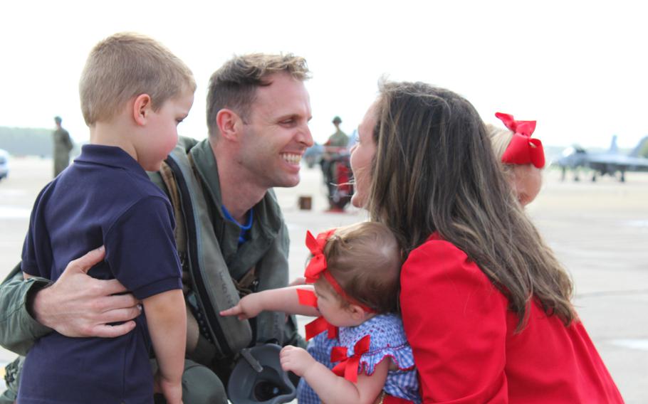 Lt. Mike Buck is greeted by his wife, Kristina, and children, 3-year-old twins Luke and Emma and 9-month-old Sofia. His unit, Strike Fighter Squadron 83 “Rampagers,” was one of four fighter jet squadrons returning from a nearly nine-month deployment with the USS Dwight D. Eisenhower Carrier Strike Group. 