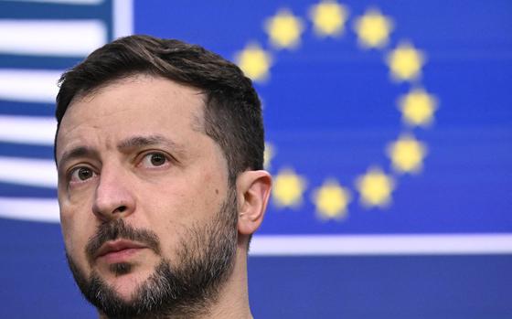 Ukraine's President Volodymyr Zelensky looks on with the European flag displayed behind during a press conference after the European Council meeting at the EU headquarters in Brussels on Dec. 19, 2024. (John Thys/AFP/Getty Images/TNS)